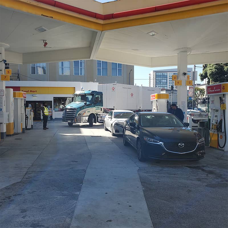 Thompson and Harvey truck driving through Shell gas station